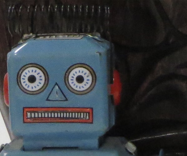 Vintage blue toy robot with a background.Vintage blue toy robot face close-up.Close-up of a toy robot's face.