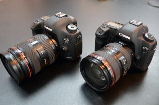 Canon EOS 5D Mark III cameras with lenses on table.