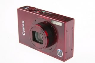 Canon IXUS 500 HS digital camera in red color on white background.