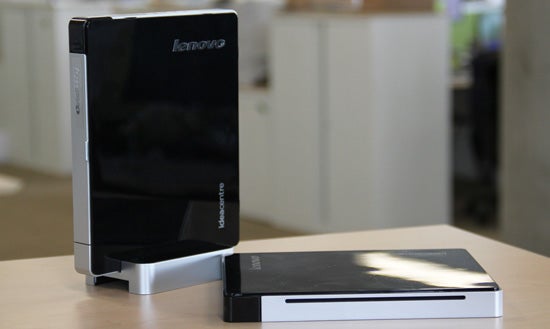 Lenovo IdeaCentre Q180 desktop PC on a desk.Hand holding Lenovo IdeaCentre Q180 mini desktop PC.
