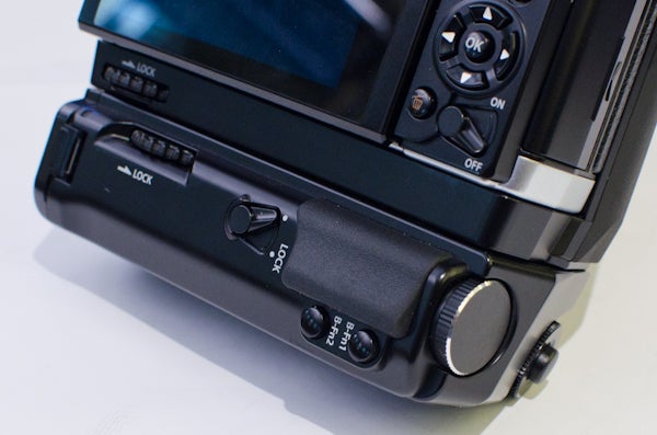 Close-up of Olympus OM-D E-M5 camera's rear controls.