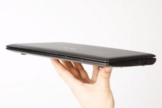 Hand holding thin Asus Eee PC X101CH netbook side view