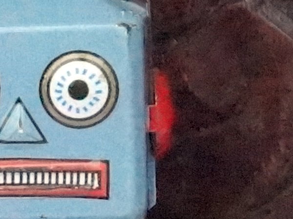 Close-up of a vintage robot toy's face