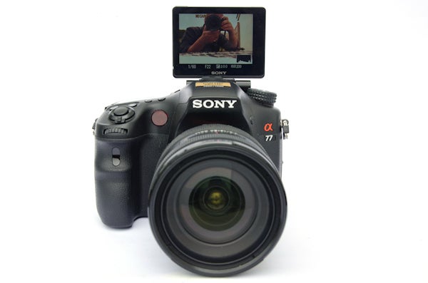 Sony Alpha A77 DSLR camera with flip screen displaying photographer.