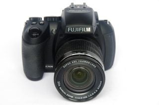 Fujifilm FinePix HS30EXR digital camera on a white background.