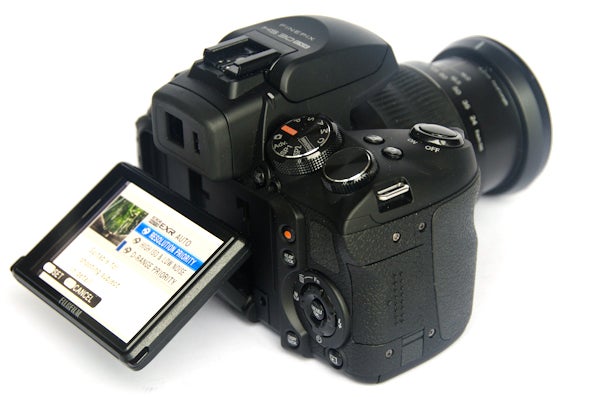Fujifilm FinePix HS30EXR camera with articulated LCD screen.