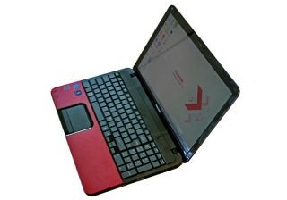 Toshiba Satellite C855 laptop with open lid on desk.
