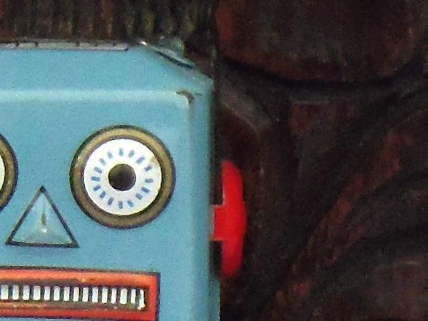 Close-up of a vintage blue toy robot face.
