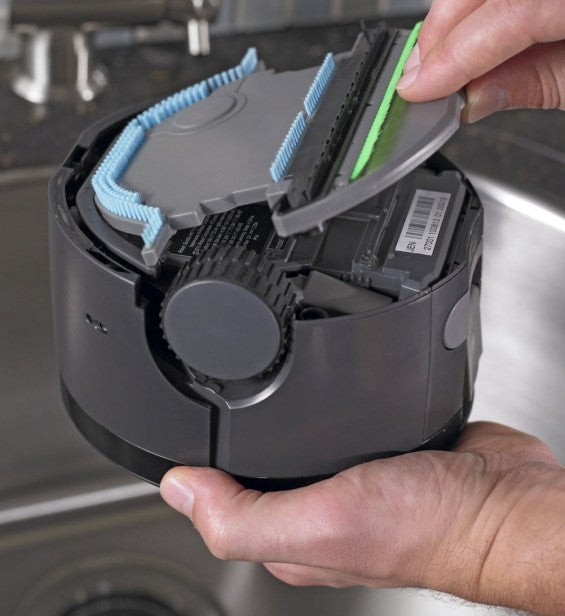 Person opening the compartment of an iRobot Scooba 230 robot mop