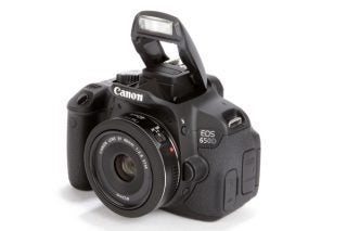 Canon EOS 650D DSLR camera with flash raised.