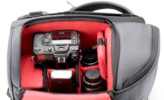 Booq Python camera bag with red padded inserts and strap.Booq Python camera bag with DSLR and lenses inside.