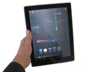 Hand holding a Disgo Tablet 9104 showing homescreen icons.