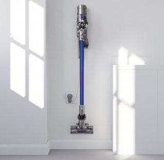 Dyson DC44 Animal vacuum mounted on wall charger.