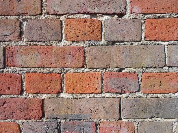 Close-up photo of a brick wall showing texture detail.