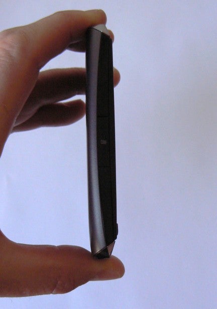 Hand holding a Nokia Asha 306 mobile phone on its side