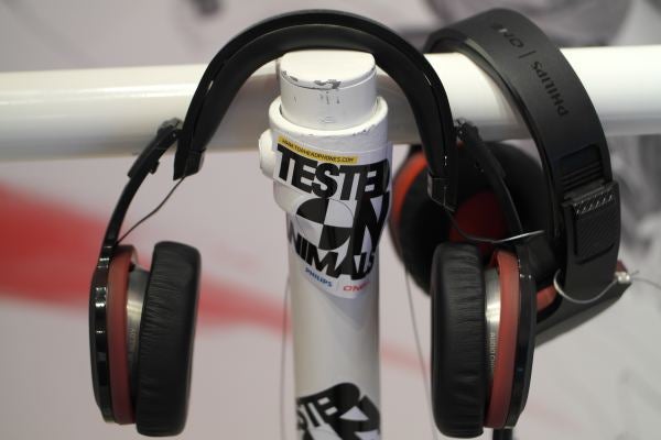 Headphones hanging on bike handlebar with a spray can labeled 