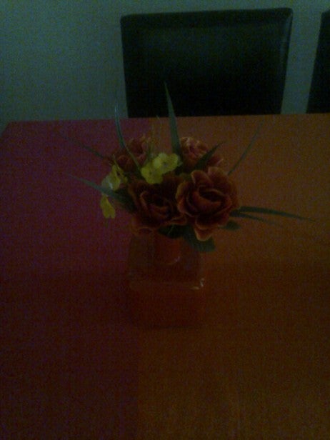 Flower arrangement on a dark table in low light conditions