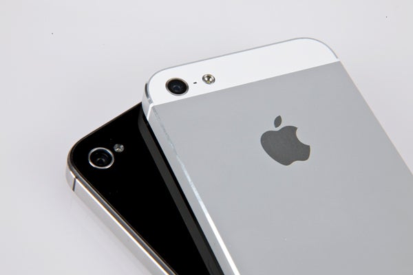 Two iPhone 5 smartphones in black and white colors.
