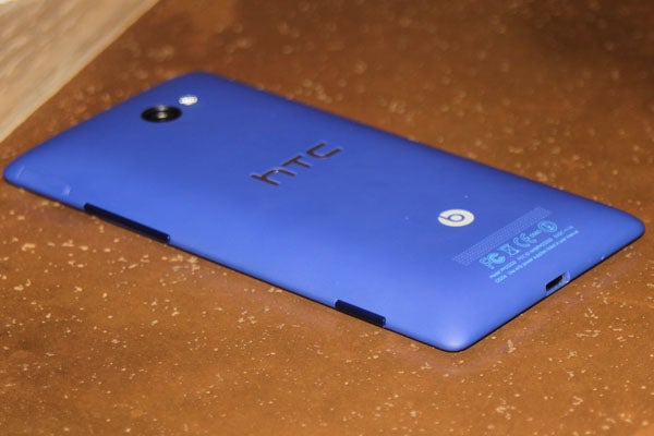 Back view of a blue HTC 8X smartphone on a table.