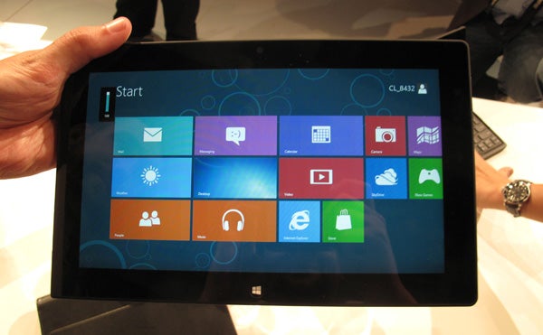 Side view of Lenovo ThinkPad Tablet 2 on a hand.Lenovo ThinkPad Tablet 2 showing Windows Start screen.