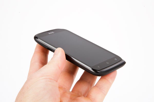 Hand holding an HTC Desire X smartphone