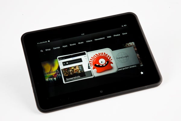 Amazon Kindle Fire HD tablet displaying colorful apps on screen.