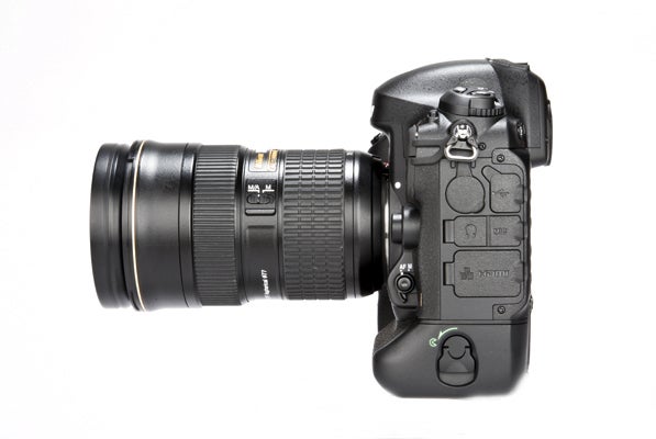 Nikon D4 DSLR camera with telephoto lens on white background.