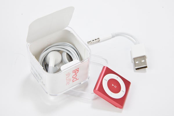 Red iPod Shuffle 2012 with earphones and USB cable.