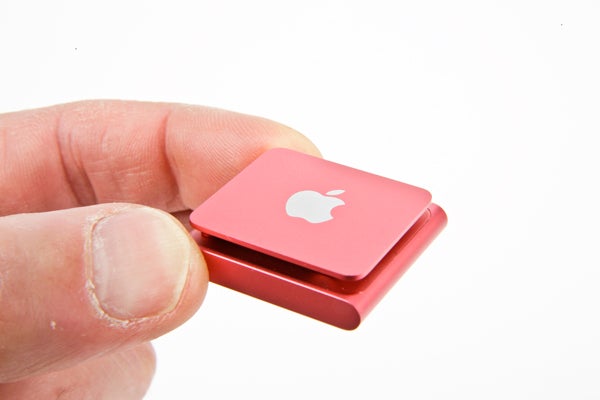 Hand holding a red iPod Shuffle 2012 model.