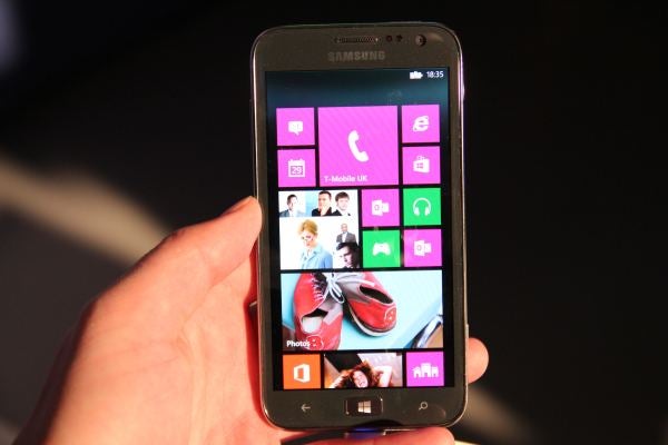 Hand holding a Samsung Ativ S displaying homescreen.