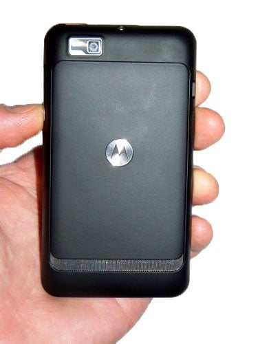 Hand holding a Motorola Motosmart smartphone from the back.