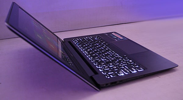 Asus Taichi laptop with dual screens open on desk.