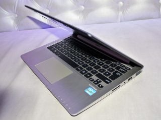 Asus VivoBook laptop open on a white surface.