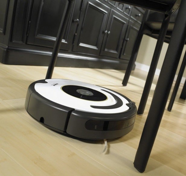 iRobot Roomba 620 vacuum cleaning under kitchen table.iRobot Roomba 620 vacuum cleaner on white background