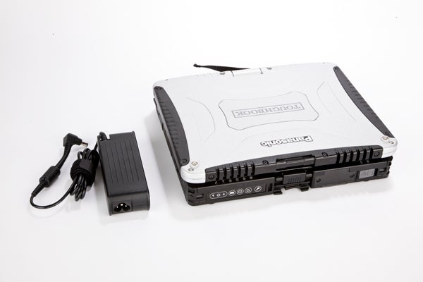 Panasonic Toughbook CF-19 with power adapter on white background
