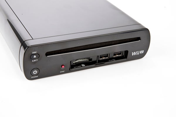 Close-up of Wii U console front panel with ports and buttons.
