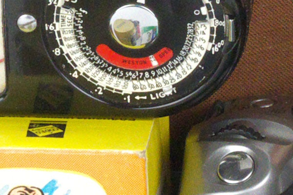 Close-up of vintage camera light meter and controls.