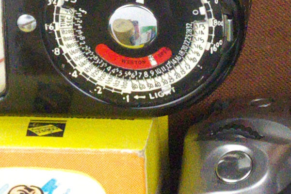 Close-up of vintage camera's light meter and controls