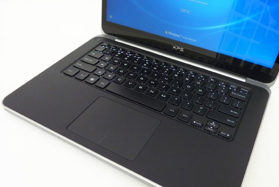 Dell XPS 14 laptop with open display showing keyboard and screen.