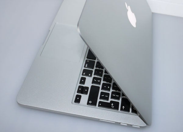 Apple MacBook Pro 13-inch partially open on table.