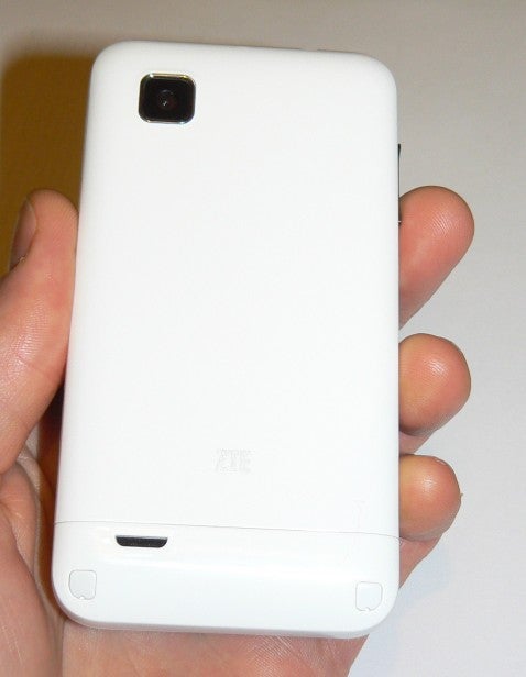 Person holding a white ZTE Kis smartphone.