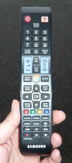 Samsung TV remote control held in a hand