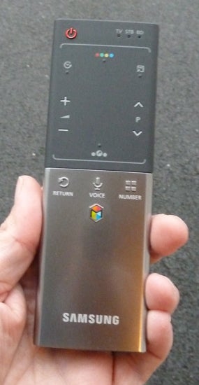 Samsung TV remote control held in a handSamsung smart TV remote control held in hand.