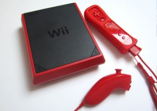 Red Nintendo Wii Mini console with matching controller and nunchuk.