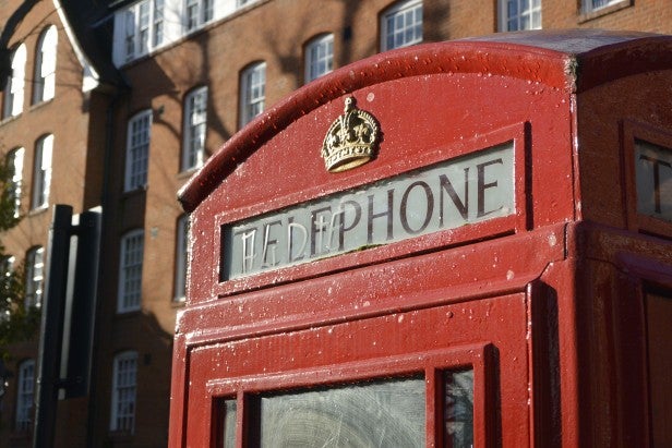 Close-up of a red telephone box with fine detail.