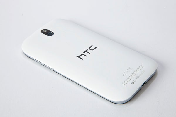 White HTC One SV smartphone showing back cover with logo.HTC One SV smartphone on a white background.Close-up of HTC One SV smartphone's upper front side.
