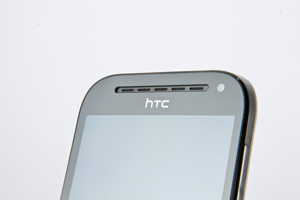 HTC One SV smartphone on a white background.Close-up of HTC One SV smartphone's upper front side.