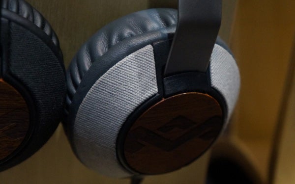Close-up of House of Marley Liberate headphones hanging on hook.