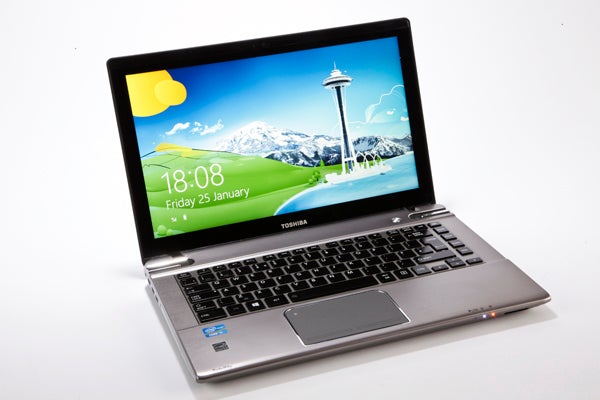 Toshiba Satellite P845T laptop with open screen displaying wallpaper.