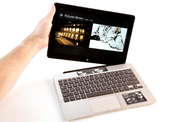 Hand holding Asus Vivo Tab with keyboard dock.